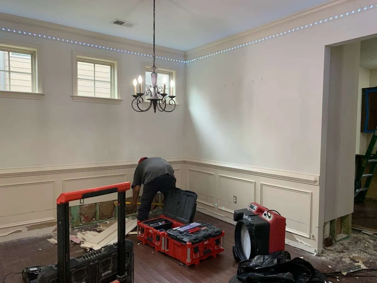 Restoration technician with professional equipment in Clinton